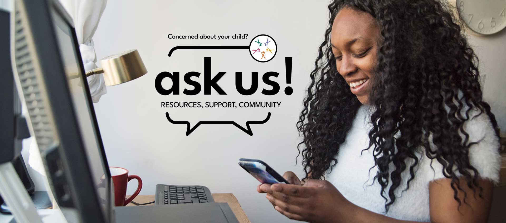 A Black American woman smiling at a smartphone screen with the Ask Us logo beside her