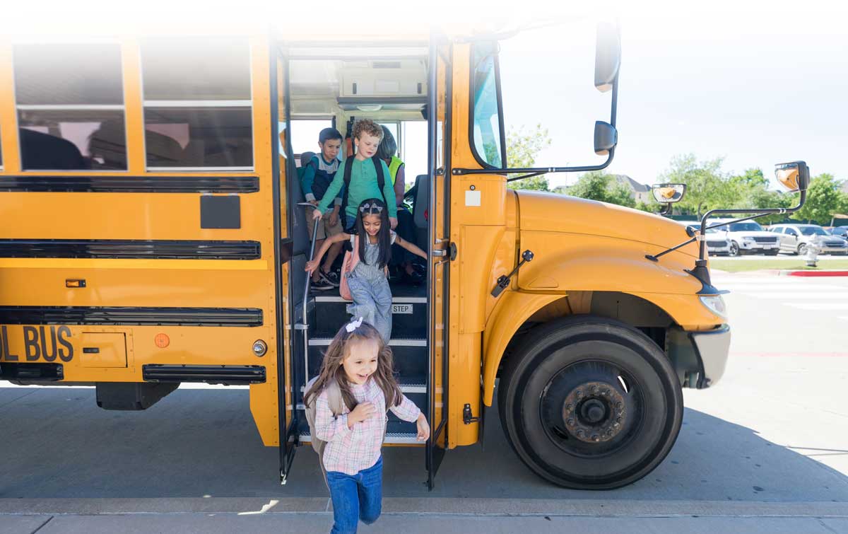 Children exit a school bus