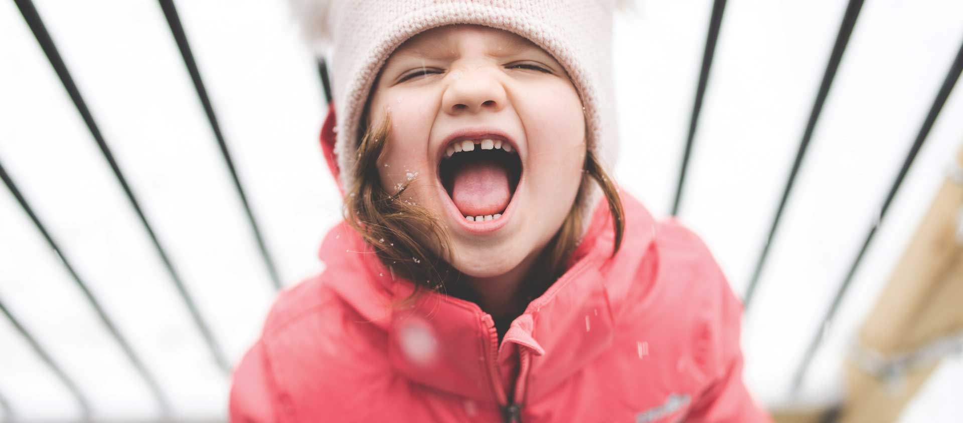A child in a snowy setting has a tantrum
